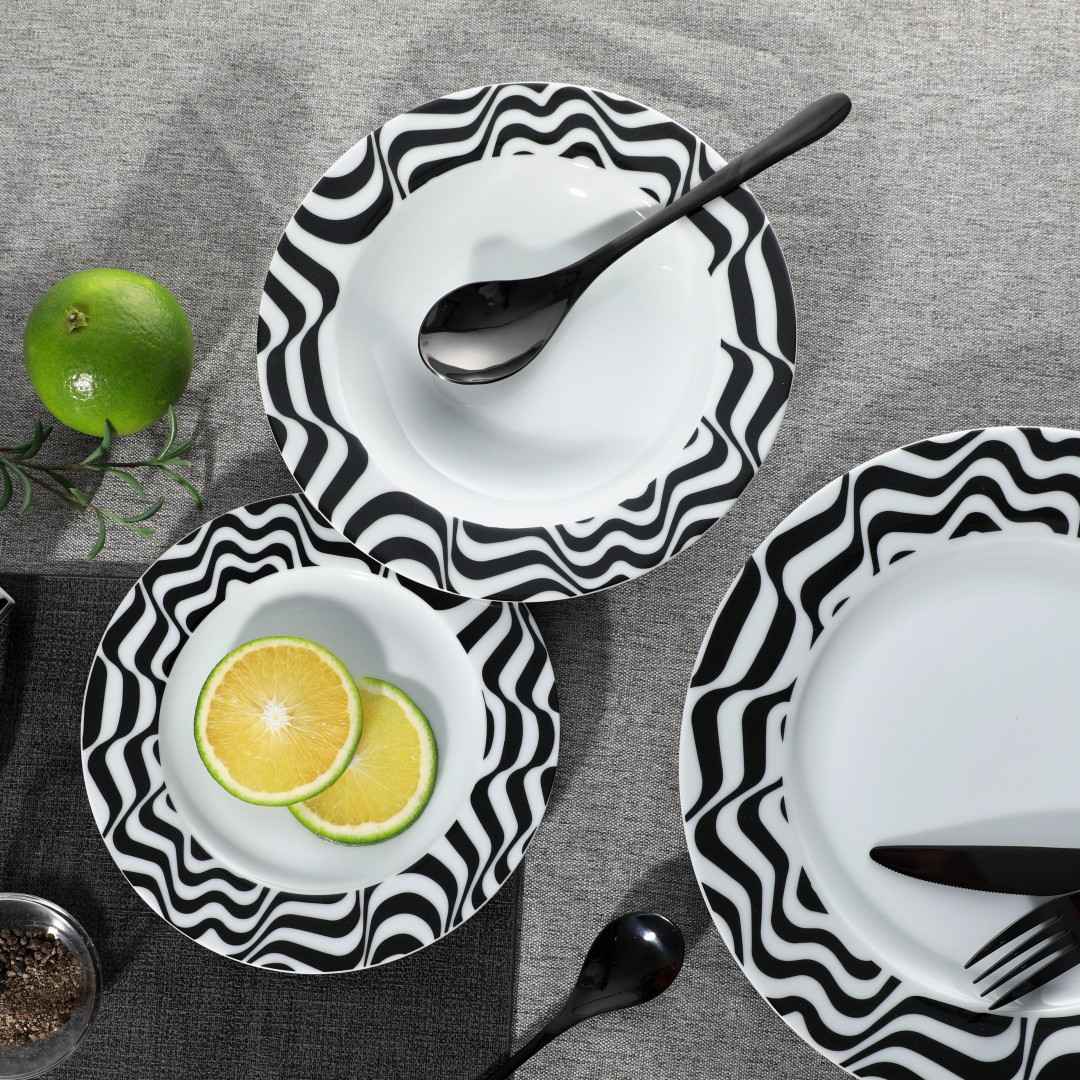 Yellow-lemon-on-a-black-striped-circular-ceramic-plate-black-flatware Yellow-lemon-on-a-black-striped-circular-ceramic-plate-black-flatware